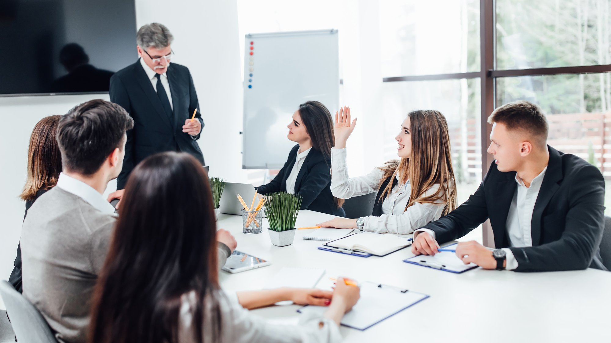 boss-businessman-holding-papers-hands-smiling-young-team-coworkers-making-great-business-discussion-modern-coworking-office