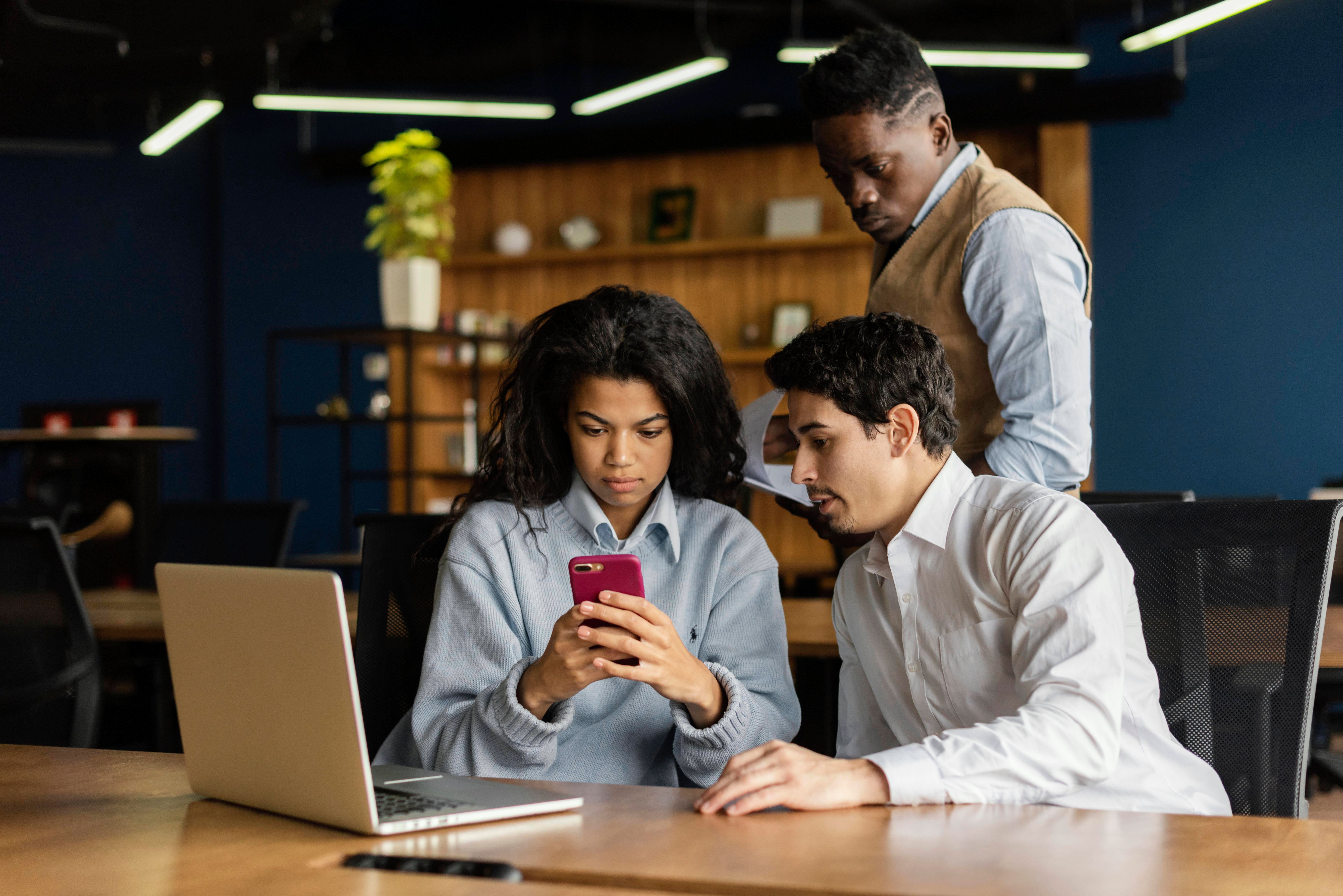 coworkers-office-working-with-laptop-smartphone